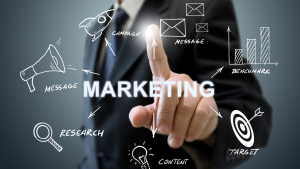 Business professional pointing at a digital marketing diagram with icons for research, message, and target.